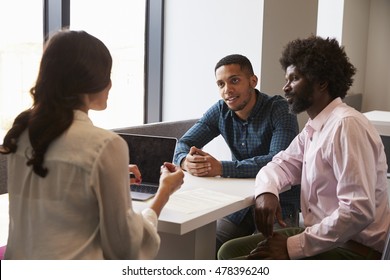 Father And Son Meeting With Female Teacher