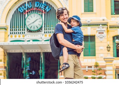 Father and son on background Saigon Central Post Office on blue sky background in Ho Chi Minh, Vietnam. The inscription on the Vietnamese "post office" - Powered by Shutterstock