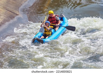 Father And Son On A Raft In Whitewater Rapids