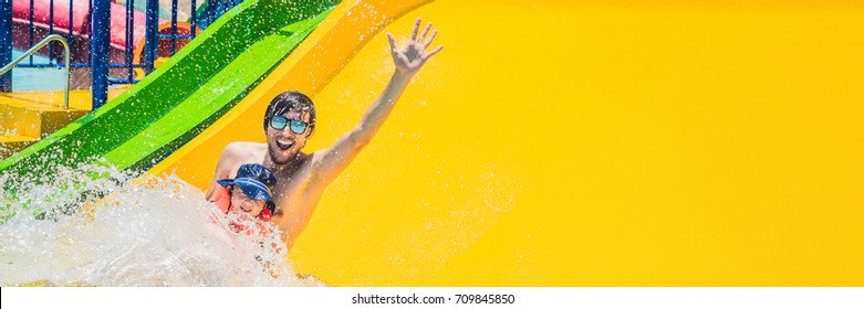 Father and son on a water slide in the water park. Long Format. - Powered by Shutterstock