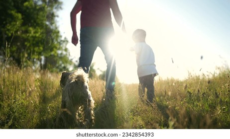 father and son in the park. dad walk with his little son baby and dog outdoors. happy family kid dream concept. people in the park. dad walk with baby boy and dog in lifestyle nature - Powered by Shutterstock