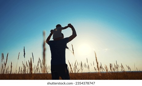father and son in the park. father's day silhouette happy family child dream concept. father carries his son on his back. dad walk with his son in nature in park silhouette lifestyle at sunset - Powered by Shutterstock