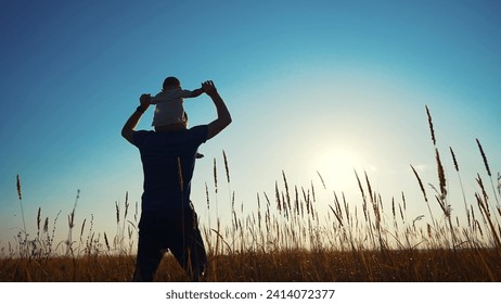 father and son in the park. father's day silhouette happy family child dream concept. father carries his son on his back. dad walk with his son in nature in park silhouette at sunset lifestyle - Powered by Shutterstock