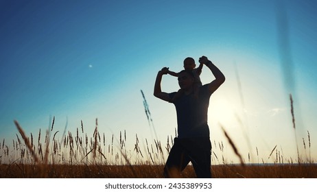 father and son in park. father's day silhouette happy family child dream concept. father carries his son on his back. dad walk with his son in nature in lifestyle the park silhouette at sunset - Powered by Shutterstock