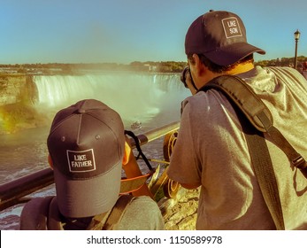 Father and son photographing together.  - Shutterstock ID 1150589978
