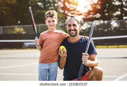 A Father and son play tennis on a summer day - Powered by Shutterstock