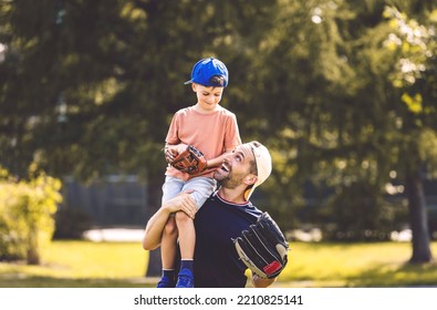 A Father And Son Playing Baseball In Sunny Day At Public Park