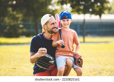 A Father and son playing baseball in sunny day at public park - Powered by Shutterstock