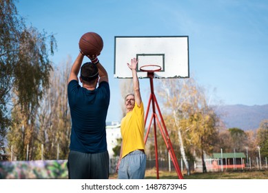 Father And Son Playing Basketball In The Park, Family Fun