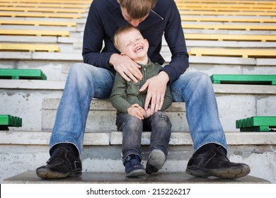 Father And Son Playing In Empty Stadium  