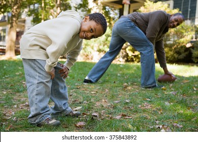 Father And Son Playing Football