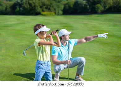Father and son playing golf