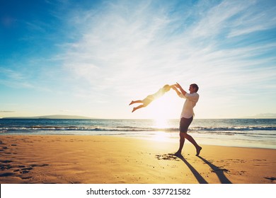 Father and Son Playing on the Beach at Sunset