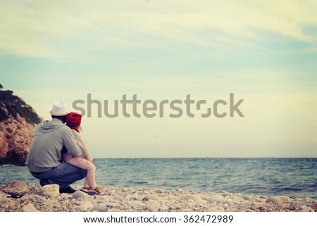 Father and son playing on the beach 