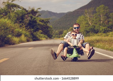 Father and son playing  on the road at the day time.  Concept of friendly family. - Shutterstock ID 1664528899