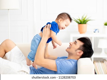 Father And Son Playing On Sofa Together - Powered by Shutterstock