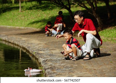 Father With Son, Playing With Remote Control Boat
