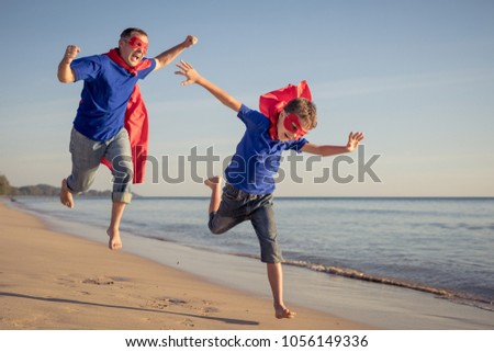 Similar – Image, Stock Photo Father and son playing superhero on the beach at the day time. People having fun outdoors. Concept of summer vacation and friendly family.