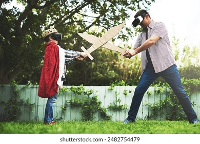 Father, son and playing with sword fight for bonding or VR in costume, cosplay or backyard at home. Fun dad, child or little boy enjoying outdoor game on grass field, lawn or virtual reality at house - Powered by Shutterstock