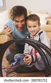 Father And Son Playing With Toy Car Race Track