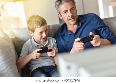 Father And Son Playing Video Game On Tv