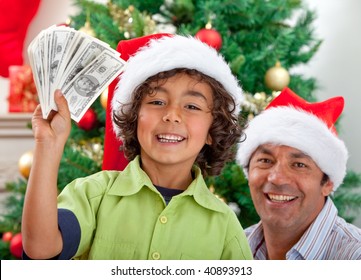 Father And Son Portrait At Christmas With Money