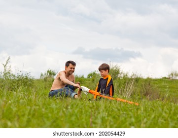 Father and son are preparing an equipment for a windsurfing - Powered by Shutterstock