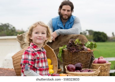 Father And Son With Produce In Truck Bed