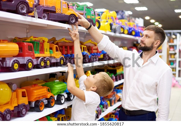 Father and son
purchase a toy car in a toy
store.