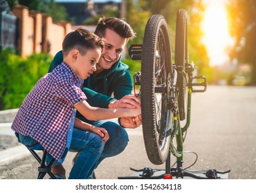 The father and son repair the bicycle together - Powered by Shutterstock