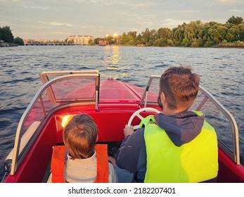 Father and son riding motor boat wearing safety vests having a ride in Neva river, Saint Petersburg - Powered by Shutterstock