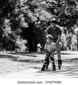 Father and son roller skating together