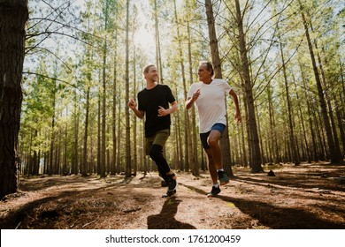 Father And Son Running In The Woods Together, Exercising And Keeping Fit