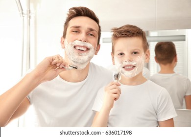 Father and son shaving in bathroom - Powered by Shutterstock