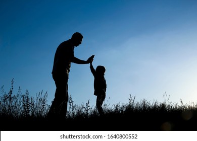 father son silhouette baseball