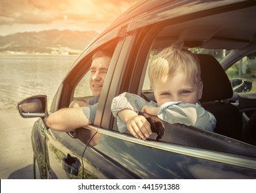 Father And Son Sitting In Car