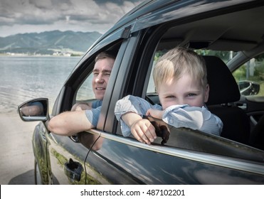 Father and son sitting in car