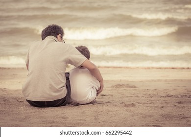 Father and son sitting on the beach of summer with vintage color tone
 - Powered by Shutterstock