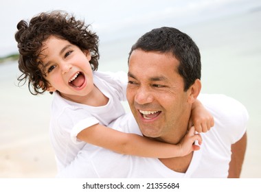 Father And Son Smiling At The Beach