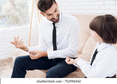 Father And Son Spend Time Together. Dad And Son In The Same Clothes. Dad Shows His Son How To Dress Cufflinks.