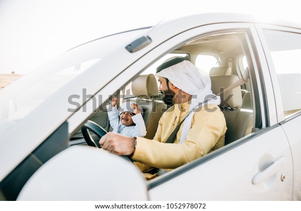 Father and\
son spending time, driving in the\
desert