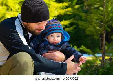 A Father And Son Stop For A Moment To Share Some Time Playing In The Snow On A Family Hiking Adventure.