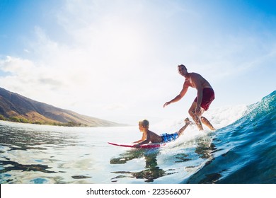 Father and Son Surfing Together Riding Blue Ocean Wave - Powered by Shutterstock