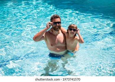 Father And Son Swimming In Pool. Family At Aquapark. Dad And Son In Pool. Summer Weekend. Family Leisure And Summer Vacation. Pool Party.