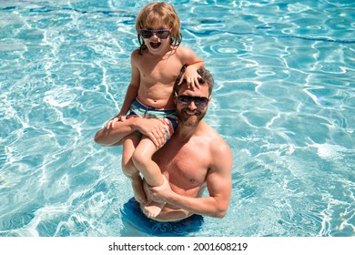 Father And Son Swimming In Pool, Summer Family. Child With Dad Playing In Swimming Pool. Family In Pool. Summer Vacation. Pool Party.