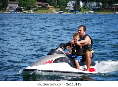 A Father And Son Take A Ride On A Personal Water Craft