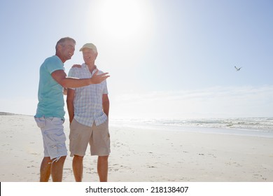 Father and son talking on sunny beach - Powered by Shutterstock