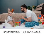 Father and son. Father teaches a child to walk on a potty. Father does begs and asks. The child is playing. Baby toiletries. Potty training.