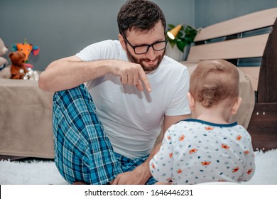 Father And Son. Father Teaches A Child To Walk On A Potty. Father Shows How To Do It Right. Dad Points A Finger. The Child Is Playing. Baby Toiletries. Potty Training