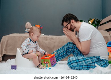 Father And Son. Father Teaches A Child To Walk On A Potty. Father Makes An Appealing Gesture With His Hands. Dad Is Tired Of Waiting. The Child Is Playing. Baby Toiletries. Potty Training